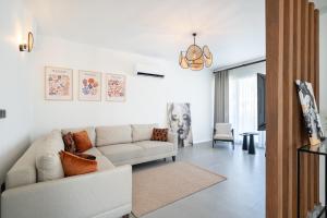 a white living room with a couch and a chair at Villa Sorrento in Fethiye
