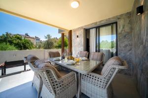 a dining room with a table and chairs on a balcony at Villa Sorrento in Fethiye