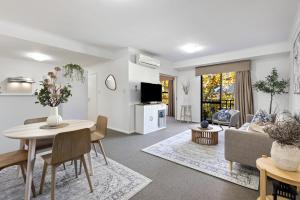 a living room with a table and a couch at Northbridge Hideaway 2BDR 1BTH in Perth
