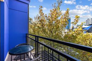 a balcony with a table and a blue wall at Northbridge Hideaway 2BDR 1BTH in Perth