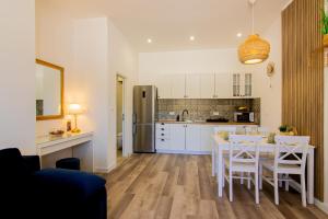 a kitchen and dining room with a table and chairs at Apartment Bunaca in Polače