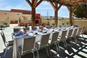 a long table and chairs on a patio at Hilton Tapestry Collection, Hotel Don Fernando De Taos in Taos