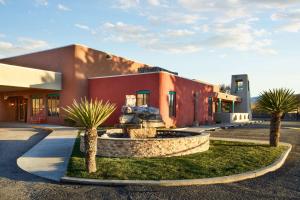 a building with a fountain in front of a building at Hilton Tapestry Collection, Hotel Don Fernando De Taos in Taos