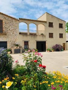 ein Gebäude mit Blumen davor in der Unterkunft Can Mas in Sant Pere Pescador