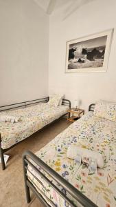 a bedroom with two beds and a picture on the wall at YOUTH HOSTEL - Central and Basic Drassanes in Barcelona