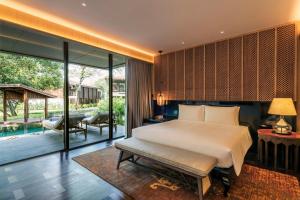 a bedroom with a bed and a pool at Andaz Pattaya Jomtien Beach, a Concept by Hyatt in Na Jomtien