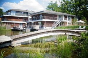 a house with a bridge over a body of water at Hotel-Residence Klosterpforte in Marienfeld