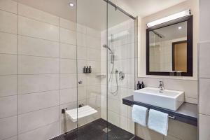 a bathroom with a sink and a shower at Lindner Hotel Nurburgring Motorsport, part of JdV by Hyatt in Nürburg