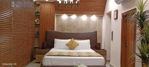 A bed or beds in a room at Galaxy Hotel & Apartments