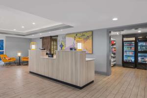 a lobby of a store with a counter and chairs at Spark By Hilton St. Augustine Historic District in St. Augustine