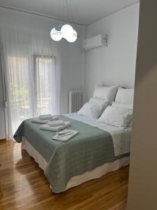 a bedroom with a bed with two towels on it at Alex’s home next to Laiko in Athens