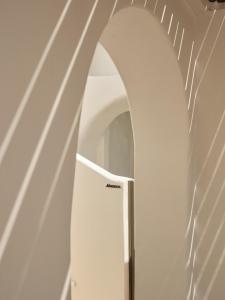 an arched hallway with a door in a stair case at Andronis Boutique Hotel in Oia