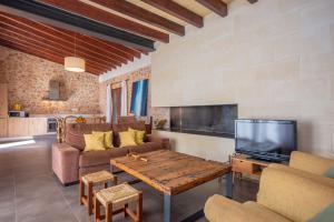 a living room with a couch and a tv at Can Pere Rapinya in Algaida