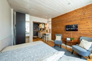 a bedroom with a bed and a wooden wall at Garden Studio next to Telliskivi & Old Town in Tallinn