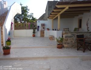 a patio outside of a house with potted plants at Harmony at Trifilianika in Trifilliánika