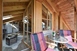 a wooden cabin with a table and two chairs at Chalet im Haus Schlossblick in Füssen