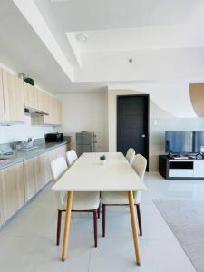 a white table and chairs in a kitchen at WV 9 Best Value Barkada Room in Iloilo City