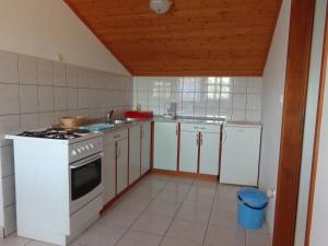 a kitchen with white cabinets and a stove top oven at Apartmani Marina in Labin +51 photos