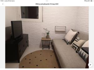 a living room with a couch and a tv at Torre con vistas in Tossa de Mar