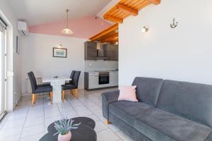 a living room with a couch and a table at Lorena in Kornić