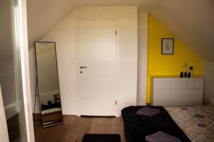 a bedroom with a white door and a mirror at Kuća za odmor Sunset in Daruvar