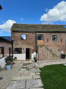 an old brick house with a stone driveway at The Tack Store, Modern 3 Bed, 6 person, Barn in a Rural Setting with Great Access in Silkstone
