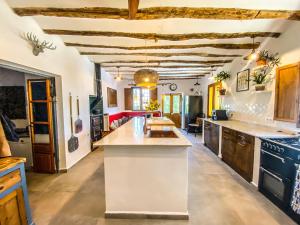 a kitchen with a large island in a room at Cueva Ventica in Benamaurel