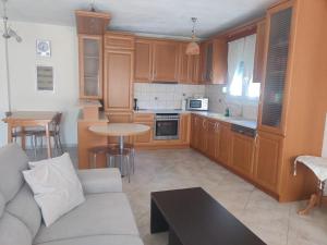 a kitchen with a couch and a table in a room at Prinos Apartment in Prinos