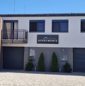 a building with a sign that reads apartment apartments at DomirexGroup Apartments in Lučenec