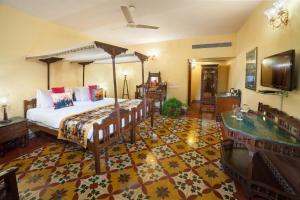a bedroom with a bed and a tub in a room at The Grand Imperial - Heritage Hotel in Agra