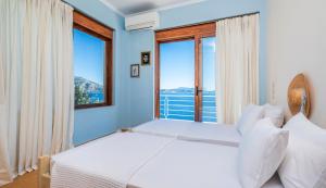 A bed or beds in a room at Iris Villas Lefkada - Karavi Villa with private sea access