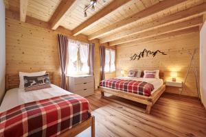 um quarto com 2 camas num chalé de madeira em Chalet Lauterbrunnen em Lauterbrunnen