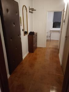 a hallway with a mirror and a dresser in a room at Apartament 4 in Przemyśl
