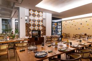 a restaurant with wooden tables and chairs and a large room at Don Salvatore Resort in Monte di Procida