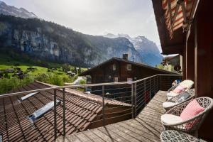 a balcony with chairs and a view of a mountain at Chalet Lauterbrunnen in Lauterbrunnen