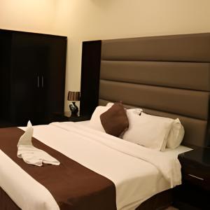 Katil atau katil-katil dalam bilik di أجنحة منازل معالي