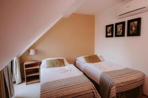 two beds in a room with a staircase at Hotel Bonaparte in Košice