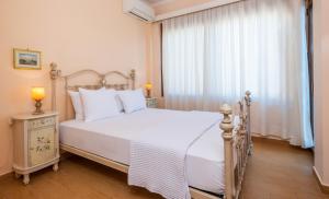 A bed or beds in a room at Iris Villas Lefkada - Karavi Villa with private sea access