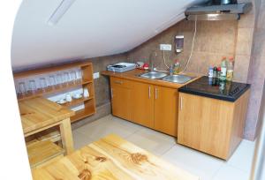 a small kitchen with a sink and a counter at Hostel km 0 in Bucharest