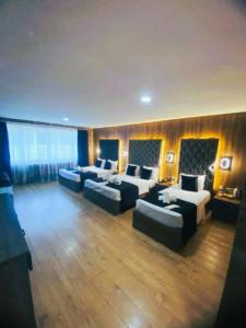 a large room with two beds and couches at Nişantaşı Diamond Hotel in Istanbul
