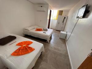 Postel nebo postele na pokoji v ubytování Dantas Hotel