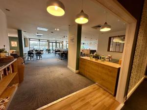 a large room with a restaurant with tables and chairs at Sweet Pea Pet Friendly Lodge in South Cerney +22 photos