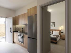 a kitchen with a door open to a bedroom at Parikia's Urban Oasis in Parikia
