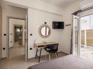 a bedroom with a desk and a mirror at Parikia's Urban Oasis in Parikia