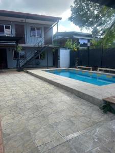 a swimming pool in front of a house at CASA FOTR LOCO in Uvita