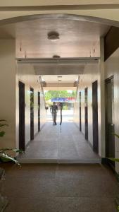 a reflection of a woman in a mirror in a building at Buona Vita resort in Panglao Island