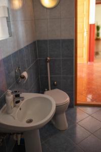 a bathroom with a toilet and a sink at Európa Szíve vendégház in Tállya