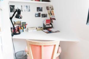 a room with a white desk with a chair at Cozy studio 2 steps from the Eiffel Tower in Paris