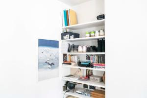 a room with white shelves with books at Cozy studio 2 steps from the Eiffel Tower in Paris
