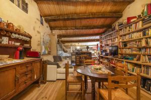 una habitación con una mesa y estanterías de libros en Les Orenetes, en Artesa de Segre